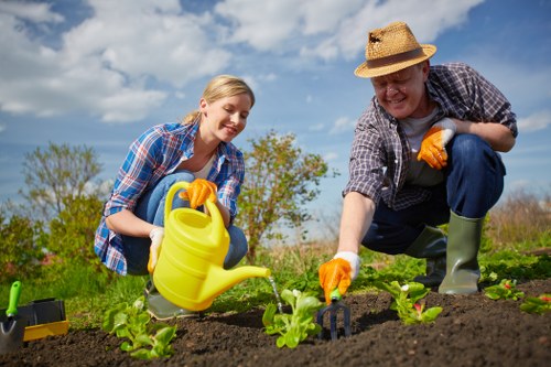 Professional gardeners working safely using PPE